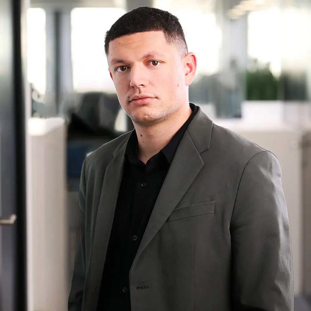 Portrait of Yonas Von Gunten, Financial advisor, taken in our Lausanne office.